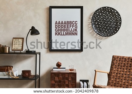 Stylish interior design composition of elegant masculine living room with mock up poster frame, brown armchair, industrial geometric shelf and personal accessories. Template.