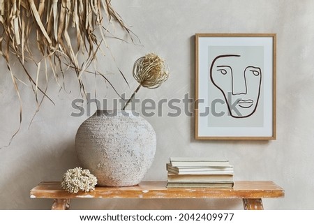 Stylish composition of cozy living room interior with mock up poster frame, bench in retro style, clay vases, crockery and straw  decoration. Rustic inspiration. Summer vibes. Beige wall. Template.