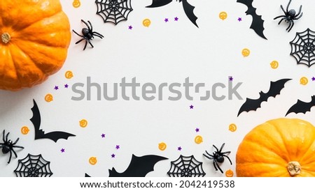 Happy Halloween holiday flat lay composition with pumpkins, spiders, bats on white background. Halloween banner mockup, greeting card design.