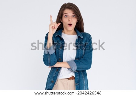 Image of excited young lady standing isolated over white background. Looking camera have an idea.