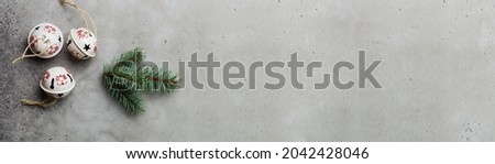 Christmas background with fir branches and cones on light concrete old background table. Selective focus. Top view with copy space.