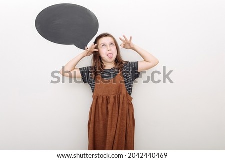 Photo of funny childish teenage girl make funky face stick tongue out isolated on white color background.