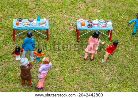 Closeup photo of tiny model figures at a fete