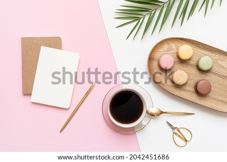 Tropical workspace concept. Notepad and tropical palm leaves. Mockup presentation workplace.