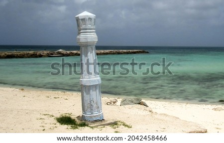 A sculpture on Noord Beach Aruba.  The background was blurred slightly by using a relatively wide aperture and to slow the flow of the water to create a dreamy affect.