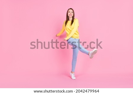 Full length body size photo smiling girl dancing at party isolated pastel pink color background
