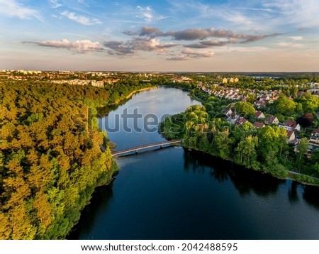 Olsztyn Lake Dlugie, bird's eye view. Wooded shores, the sky reflecting in the water table and a bridge over the lake - Warmia and Masuria, Poland Royalty-Free Stock Photo #2042488595