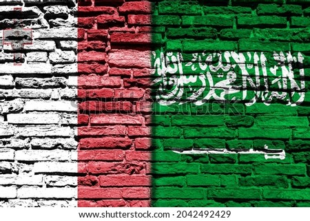 Background with flag of Malta and Saudi Arabia on a brick wall