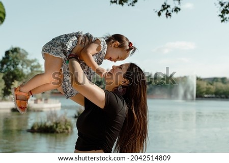 Little girl and her mother playing in the  park