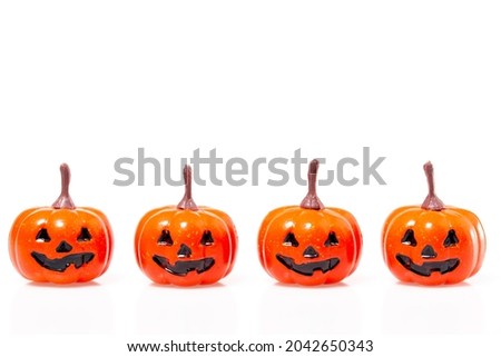 four miniature pumpkins with smiling face isolated on white background. Halloween concept.