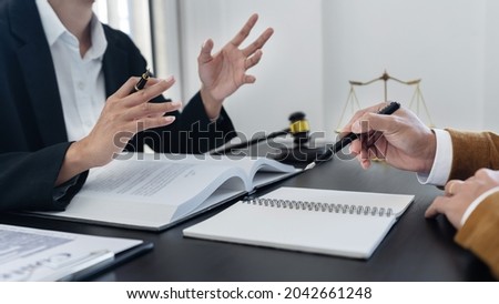 law,libra scale and hammer on the table, 2 lawyers are discussing about legal provision, law matters determination, body language. Royalty-Free Stock Photo #2042661248