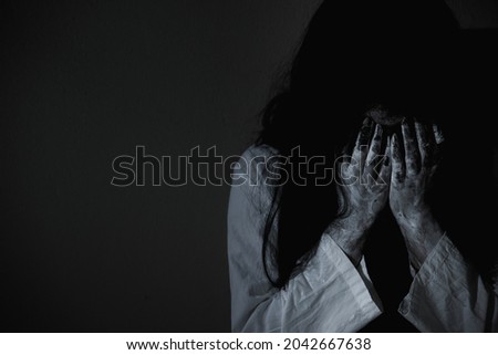 Woman ghost horror sitting crying and have her hands close the face, halloween concept Royalty-Free Stock Photo #2042667638