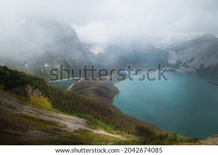 Rocky Mountains blue lakes under mist and rainbow in the Kananaskis
