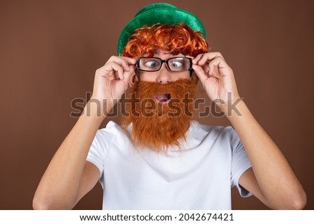 St.Patrick 's Day. Funny guy with a red beard on a brown background.