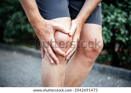 Meniscus tear in man athlete's knee, sports injuries concept Royalty-Free Stock Photo #2042691473