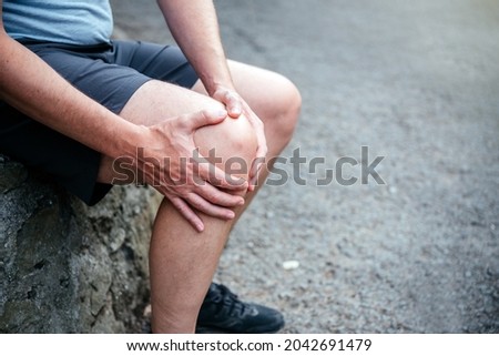 A man athlete suffering from knee ligamant tear Royalty-Free Stock Photo #2042691479