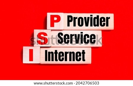 On a bright red background, light wooden blocks and cubes with the text ISP Internet Service Provider Royalty-Free Stock Photo #2042706503