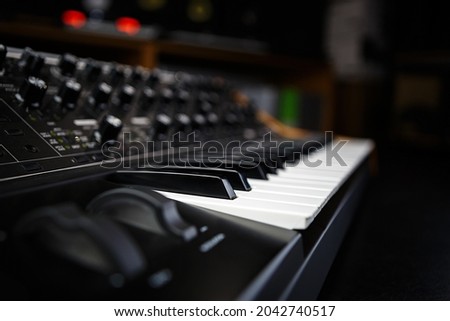 Buy synthesizer piano in music store. Professional analog synth device with classic pianist keyboard and regulators. Sound recording studio equipment for sale  Royalty-Free Stock Photo #2042740517
