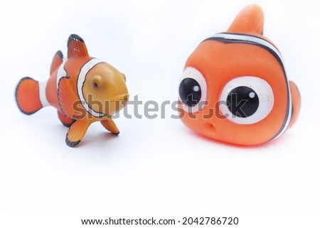 Clown fish toy on white background. Selective focus.