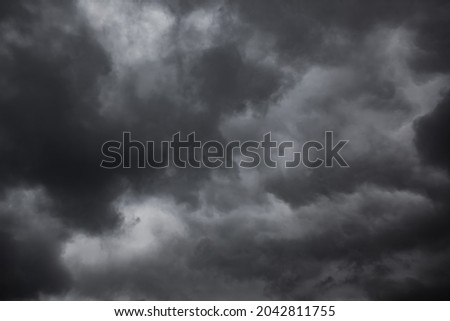 Dramatic sky with black stormy rainclouds, may be used as background Royalty-Free Stock Photo #2042811755