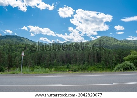 Mountain peaks and asphalt highway. Russia, mountain Altai