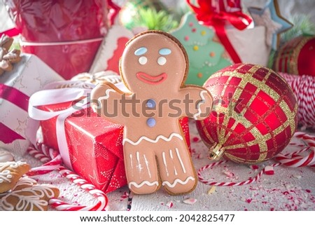  Christmas gingerbread cookies, with festive mugs for hot chocolate, Christmas decor and baubles, white background copy space