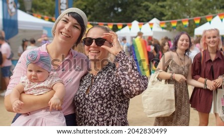  LGBT family on Pride festival to commemorate the history and culture of the movement for their equality and enlightenment, education against homophobia and transphobia Royalty-Free Stock Photo #2042830499