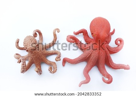 Octopus toy on white background. Red and brown octopus toys. 