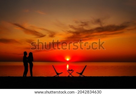 silhouette of romantic couple of lovers hug and kiss at colorful sunset on background .love concept