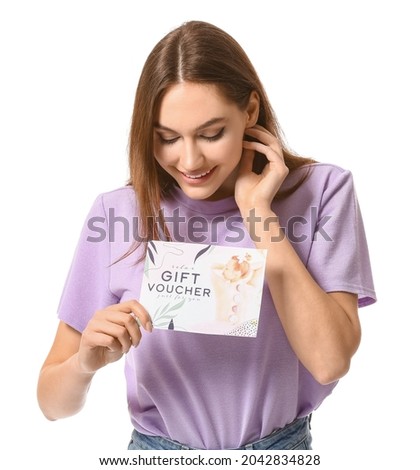 Young woman with gift voucher for massage on white background