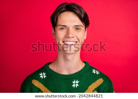 Photo of cheerful sincere candid guy shiny beaming smile wear ugly sweater isolated red color background