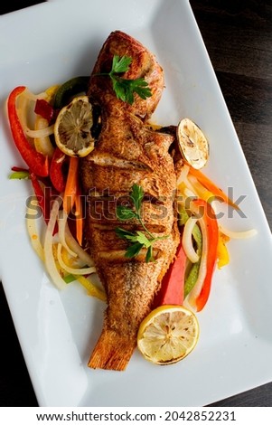 Grilled red snapper. Grilled fish. Traditional Classic American or French Seafood Restaurant menu item, whole grilled fresh caught halibut or sea bream Fish served with chilled gazpacho and rose.  
