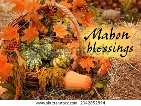 Mabon blessings greeting card. pumpkins and leaves in basket outdoor. symbol of Autumn harvest, Mabon sabbat. fall season. autumn background Royalty-Free Stock Photo #2042852894