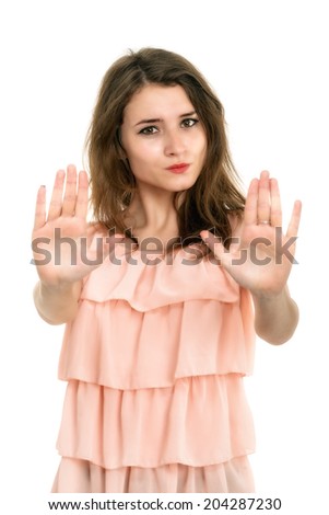 Lady making stop gesture with her palm, isolated on white
