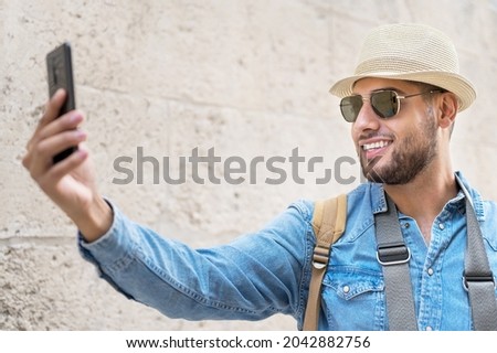 Happy tourist taking selfie in old city. High quality photo.