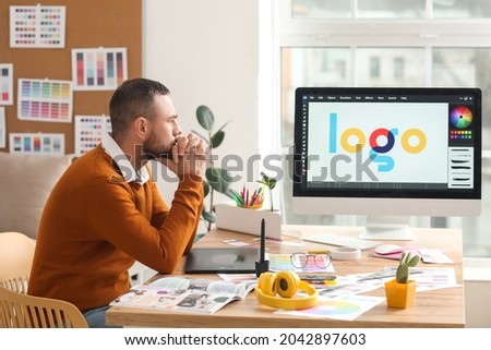Male designer working in office Royalty-Free Stock Photo #2042897603