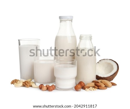 Vegan milk and different nuts on white background