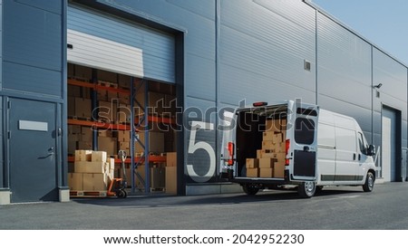Outside of Logistics Warehouse with Open Door, Delivery Van Loaded with Cardboard Boxes. Truck Delivering Online Orders, Purchases, E-Commerce Goods, Wholesale Merchandise. Royalty-Free Stock Photo #2042952230