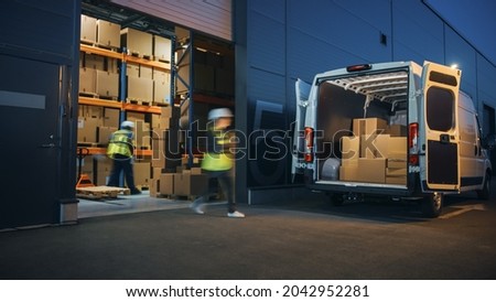 Outside of Logistics Distributions Warehouse Diverse Team of Workers Loading Delivery Truck with Cardboard Boxes. Online Orders, Purchases, E-Commerce Goods, Supply Chain. Blur Motion Shot. Royalty-Free Stock Photo #2042952281
