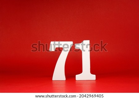 Seventy one ( 71 ) white number wooden Isolated Red Background with Copy Space - New promotion 71% Percentage   Business finance or birthday Concept - advertise banner picture online with copy space