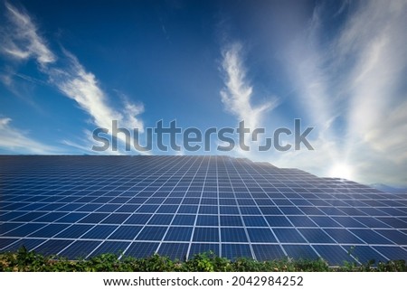 Solar energy or photovoltaic park with panels and blue sky background suggesting concept of green future