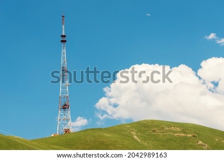 A television or cellular tower for communication on a hill in a rural area.