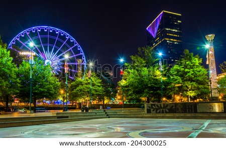 Ferris wheel and buildings seen from Olympic Centennial Park at night in Atlanta, Georgia.