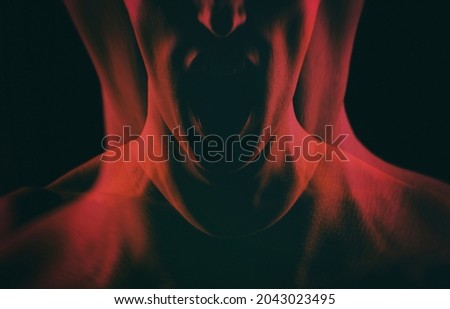 Girl shouts abstraction. Creepy screaming woman on a black background. Double exposure.  Royalty-Free Stock Photo #2043023495