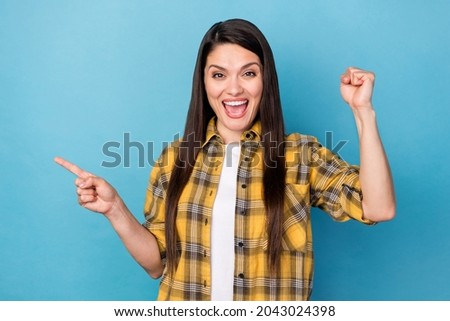 Photo of mature woman happy smile indicate finger empty space advertise select rejoice victory isolated over blue color background