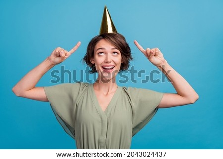 Photo of impressed millennial brunette lady point cap wear khaki blouse isolated on blue color background