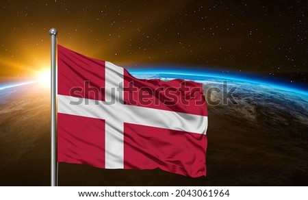 Denmark national flag cloth fabric waving on beautiful  sky.