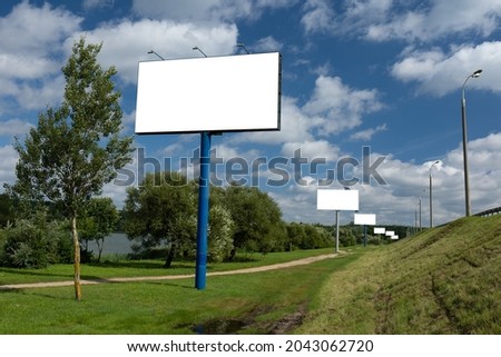 Background for design, billboards on city streets and along roads in the summer day
