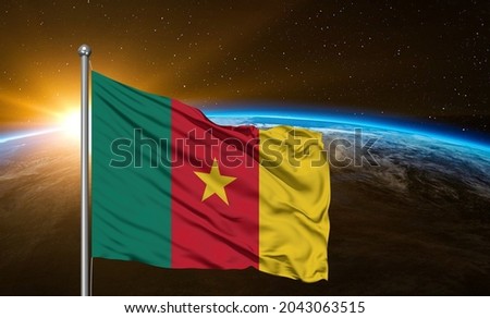 Cameroon national flag cloth fabric waving on beautiful  sky.