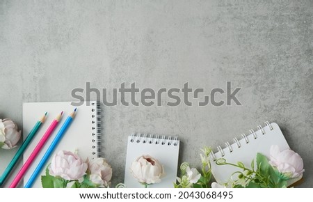 Slate Board Decorated With Petals And Pink Flowers Of Peonies On A Gray Concrete Background With